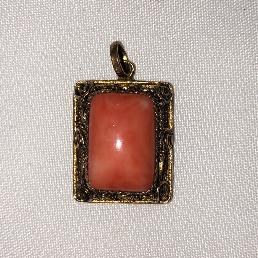 Vintage rectangular orange coral pendant in filigree metal
setting